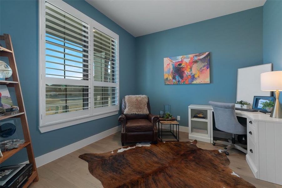 Office space with wood finished floors and baseboards