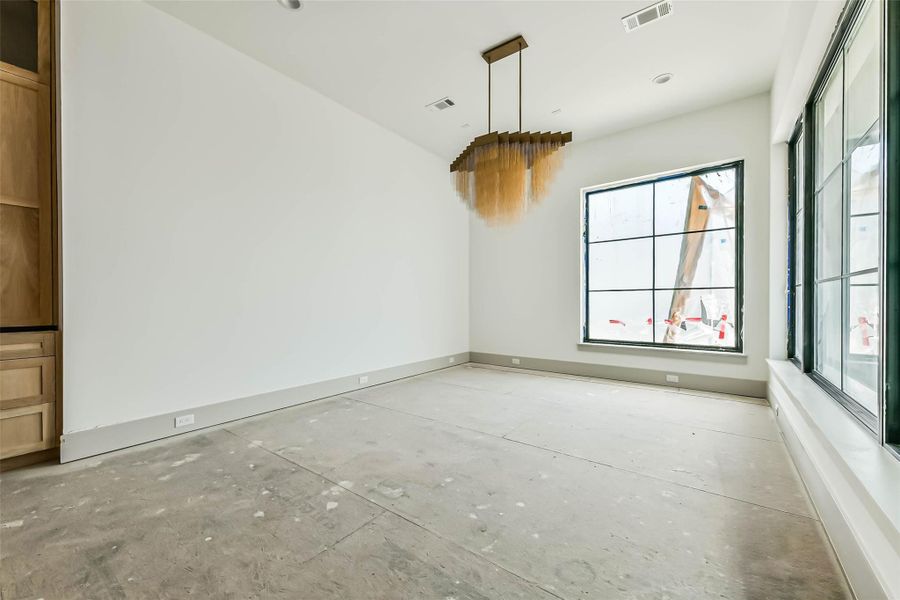 Note the walls of windows overlooking the veranda and back yard areas. The custom chandelier elevates the space. This is a progress picture from May 26th.