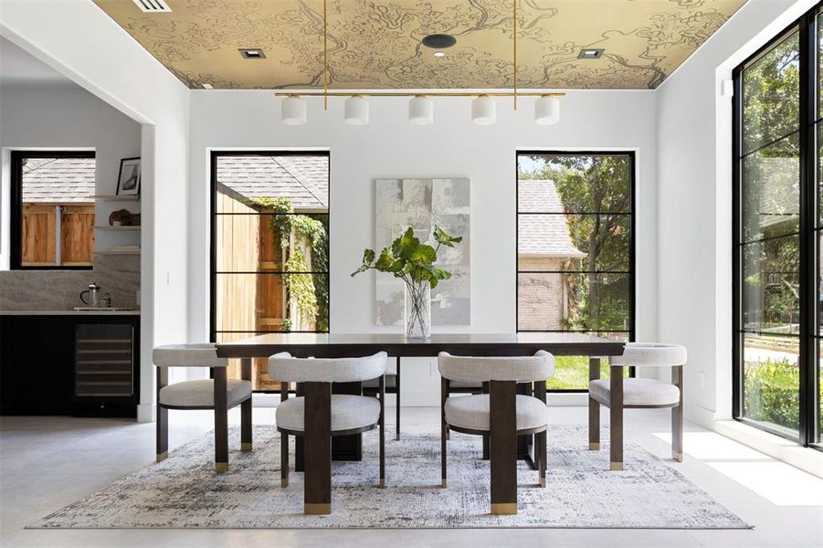 Dining room featuring sink, beverage cooler, and a wealth of natural light