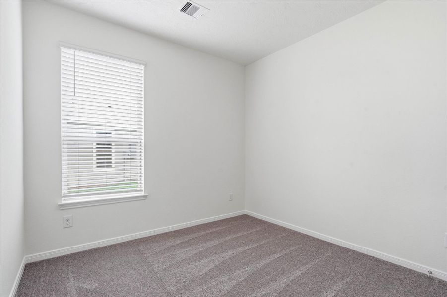 This secondary bedroom offers comfort and style with plush carpeting, neutral paint tones, recessed lighting, a large window with blinds, and a generously sized closet. This secondary bedroom offers comfort and style with plush carpeting, neutral paint tones, recessed lighting, a large window with blinds, and a generously sized closet.