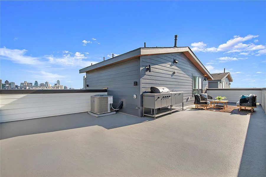 Back of house with a patio and a skyline view Back of house with a patio and a skyline view