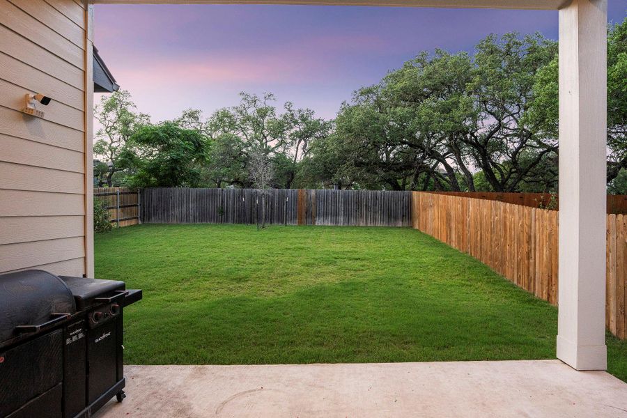 A spacious backyard with mature trees provides ample room for outdoor activities.