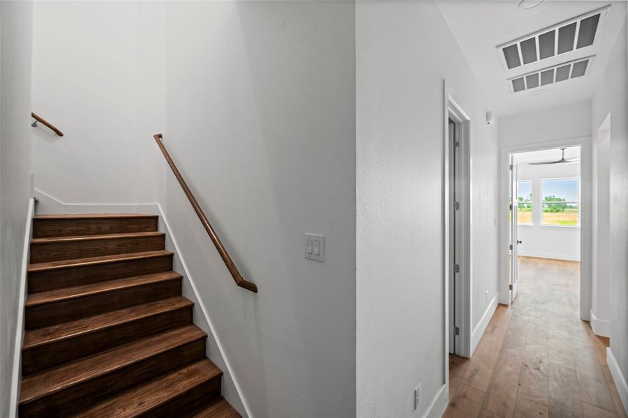 Stylish wooden staircase leads to the upper level, enhancing the home's charm and accessibility.