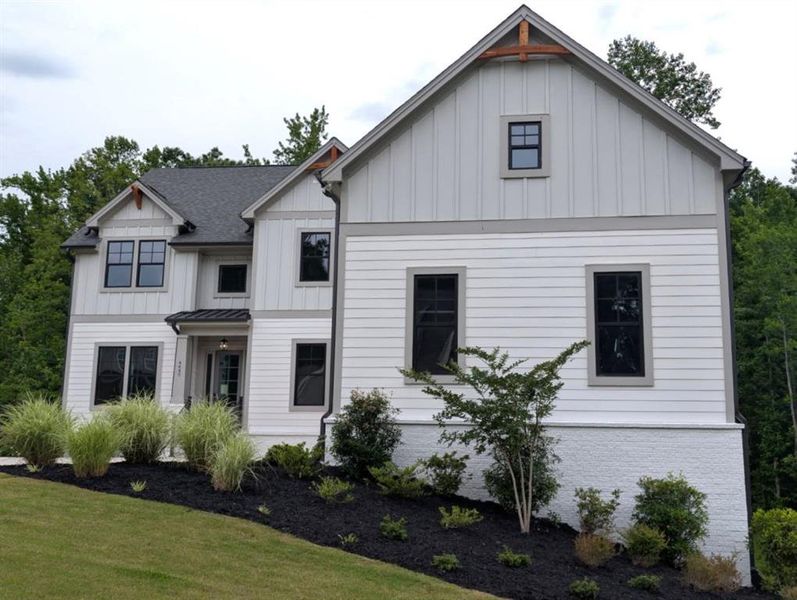 Front exterior of a new home in Arden on Lanier, Cumming, GA, highlighting curb appeal (Image 2). Front exterior of a new home in Arden on Lanier, Cumming, GA, highlighting curb appeal (Image 2).