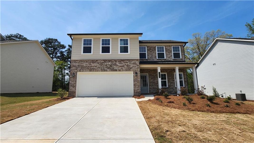 Front exterior of a new home in The Estates at Casteel, Bethlehem, GA, highlighting curb appeal (Image 1). Front exterior of a new home in The Estates at Casteel, Bethlehem, GA, highlighting curb appeal (Image 1).