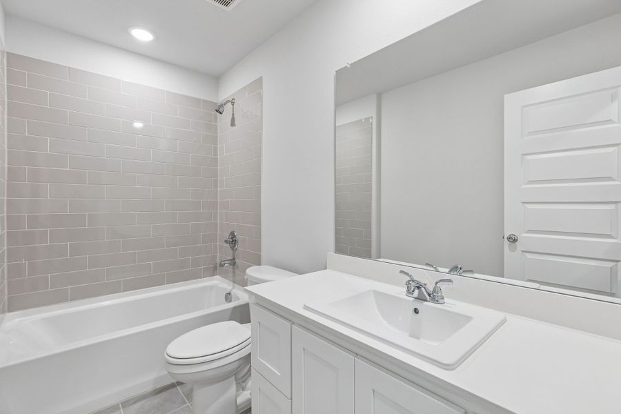 Bathroom in the Harrison home plan by Trophy Signature Homes – REPRESENTATIVE PHOTO