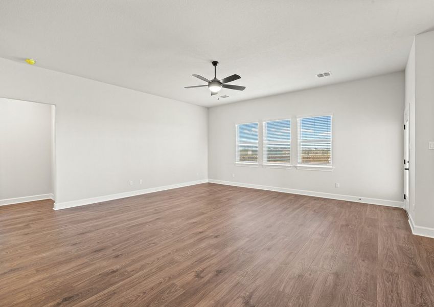 The family room has a large window with a view of the back yard
