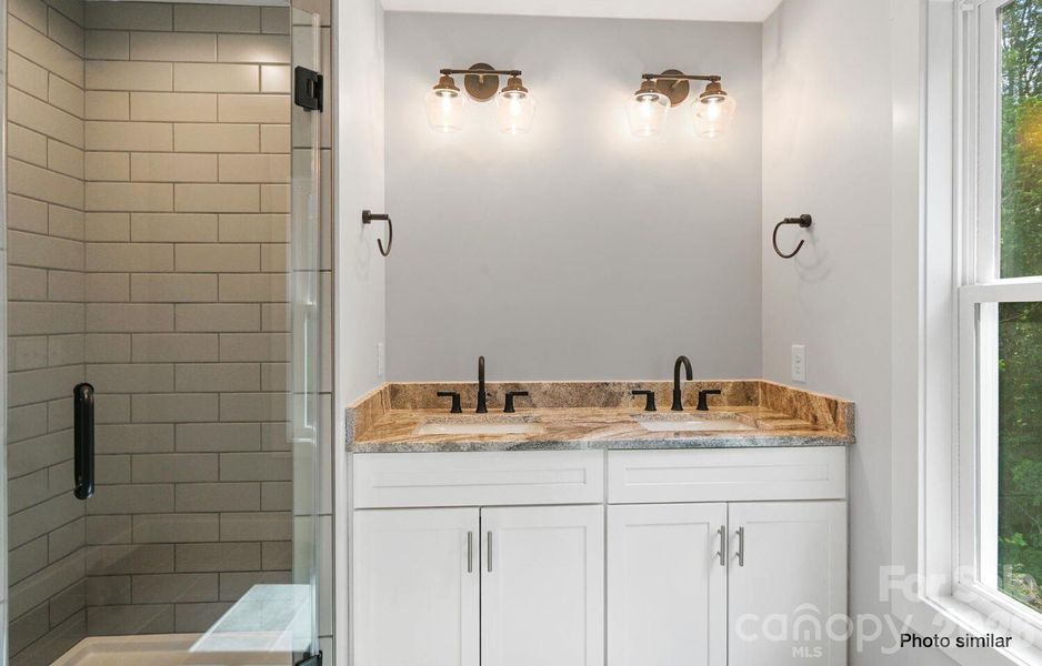 Primary Bathroom with tile shower and granite counters Primary Bathroom with tile shower and granite counters