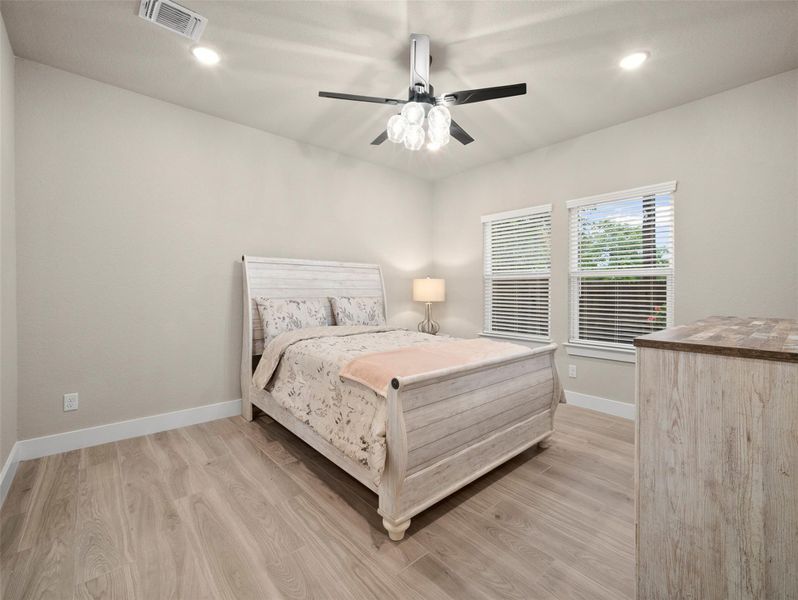 Bedroom with recessed lighting, light wood-style floors, and a ceiling fan Bedroom with recessed lighting, light wood-style floors, and a ceiling fan