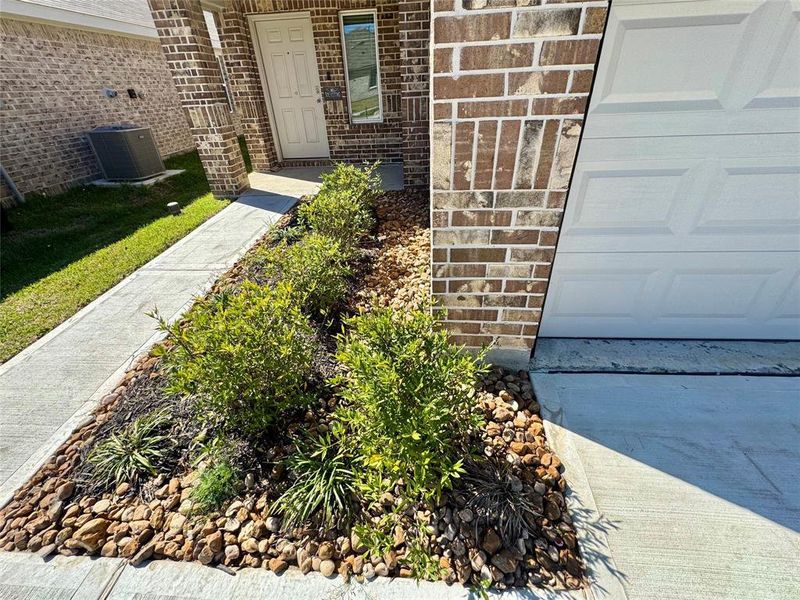 Freshly landscaped, cast stone address plaque