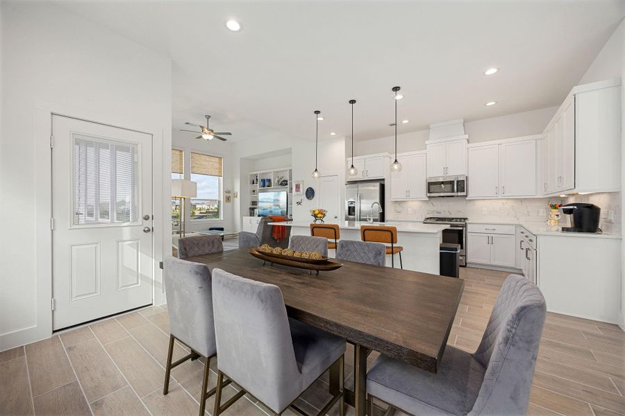 The dining area is open to the kitchen and living room. The second floor patio is located right off of the dining room as well.