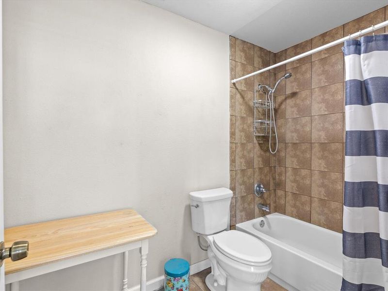 Full bath featuring shower / tub combo and toilet Full bath featuring shower / tub combo and toilet