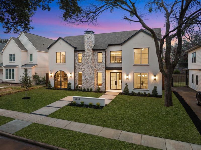 View of front of house featuring a lawn, a chimney, stone siding, and stucco siding View of front of house featuring a lawn, a chimney, stone siding, and stucco siding