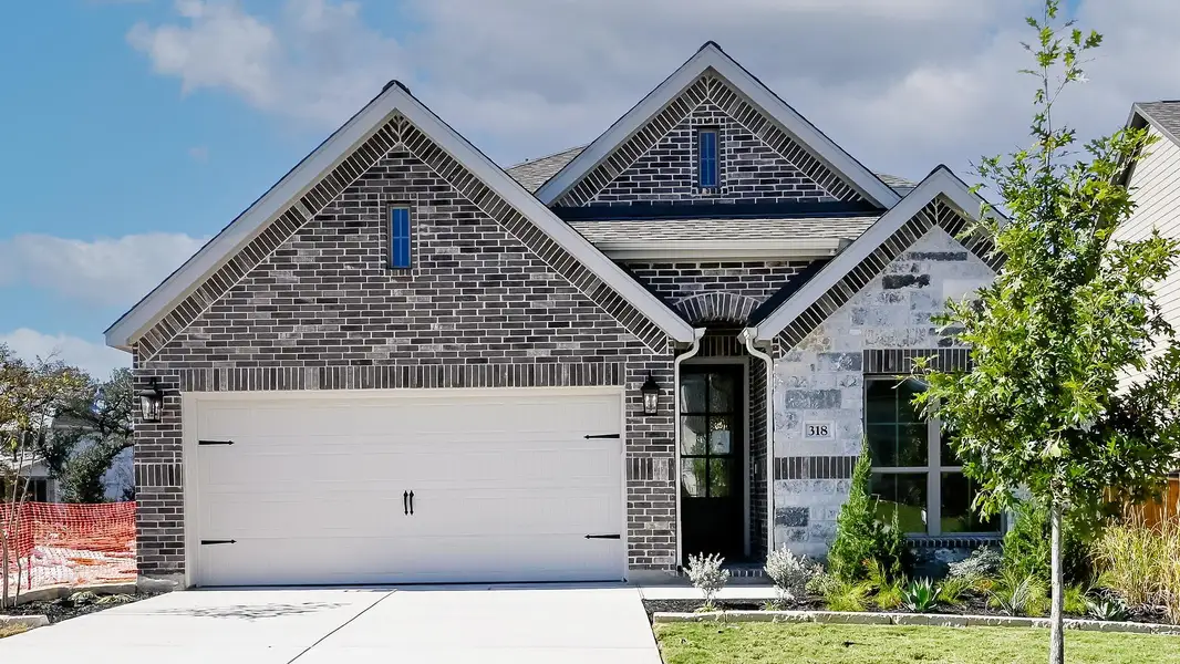 Front exterior of a new home in 6 Creeks 50', Kyle, TX, highlighting curb appeal (Image 1).