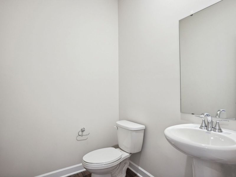The half bathroom is conveniently located on the first floor for guests.