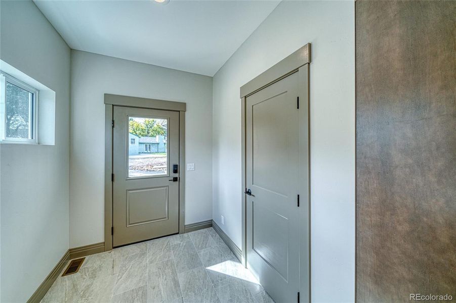 Coat closet and exterior door access to the back.