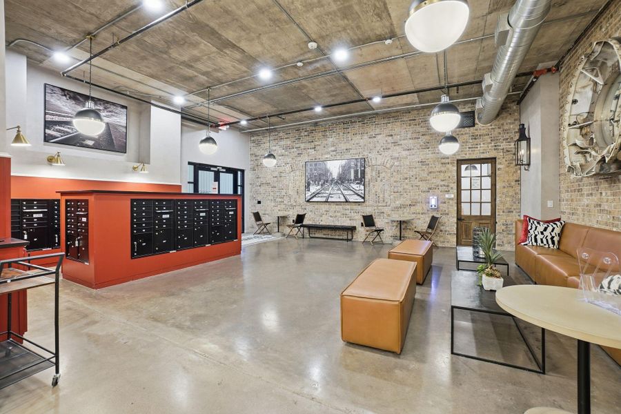 Common area with a high ceiling and brick wall