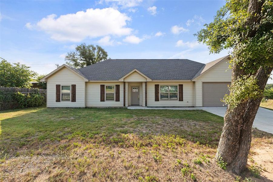 Ranch-style house with a garage and front yard