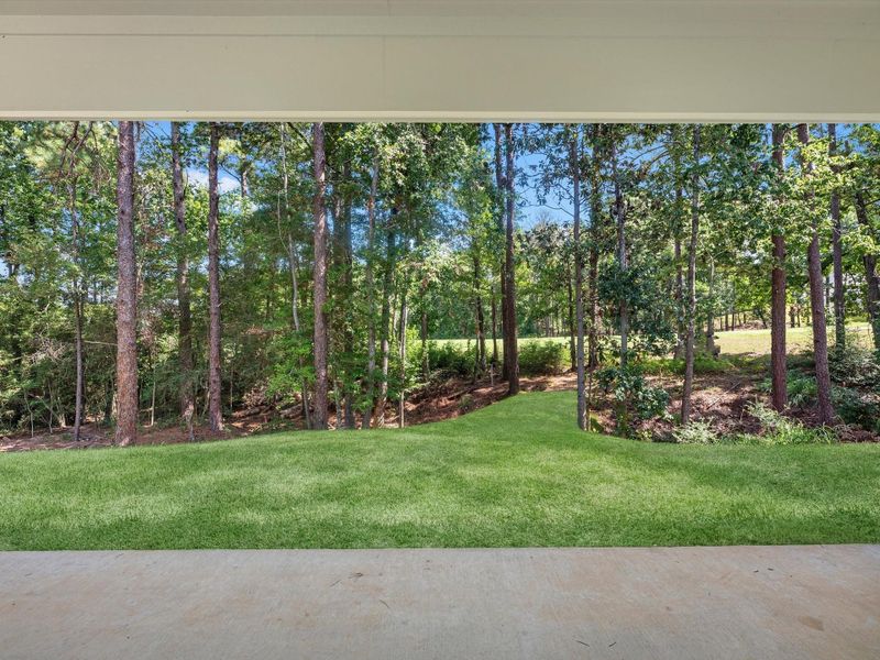 A tranquil backyard setting overlooking the golf course. Excessive dirt work was completed to offer ample functional space to the property and bridge access to the course