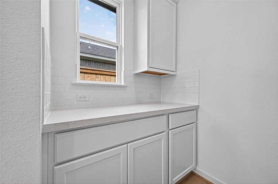 This charming butler’s pantry provides extra counter space, cabinetry, and a convenient prep area, making it perfect for entertaining or keeping the kitchen organized and clutter-free. This charming butler’s pantry provides extra counter space, cabinetry, and a convenient prep area, making it perfect for entertaining or keeping the kitchen organized and clutter-free.