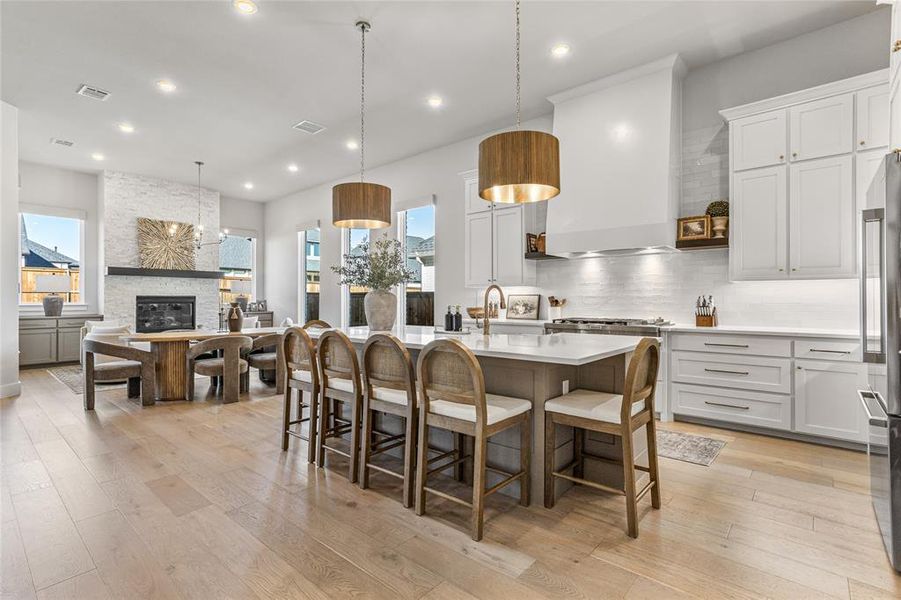 6 person seating at kitchen island next to the open dining area that ends at the hearth room! Just stunning!