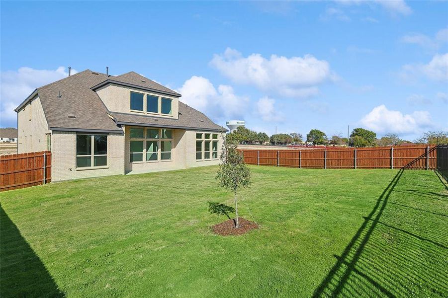 Rear view of house with a yard