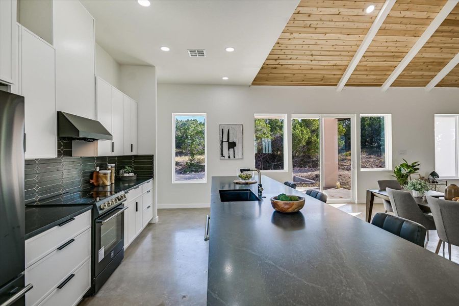 Kitchen featuring wooden ceiling, black / electric stove, decorative backsplash, finished concrete flooring, and recessed lighting