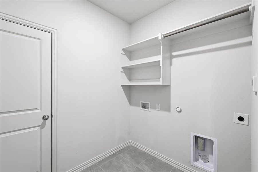 Laundry room with washer hookup, gas dryer hookup, hookup for an electric dryer, and light tile patterned floors Laundry room with washer hookup, gas dryer hookup, hookup for an electric dryer, and light tile patterned floors