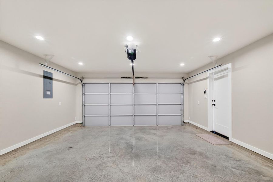 The completely finished 2-car garage features a polished concrete floor, recessed lighting, automatic opener, electrical panel, and an interior entry door. In a neighborhood where parking is a premium, this ground-floor garage adds significant practical value and security.