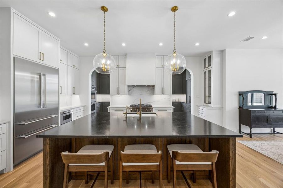 The kitchen features a beautiful soapstone island, complemented by high-end Thermador built-in appliances, including a gas cooktop with a convenient griddle insert, perfect for family breakfasts or weekend brunches.
