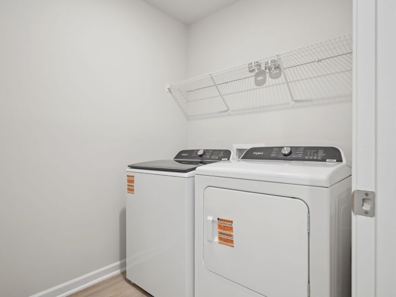 A dedicated laundry area is tucked away from the upstairs bedrooms.