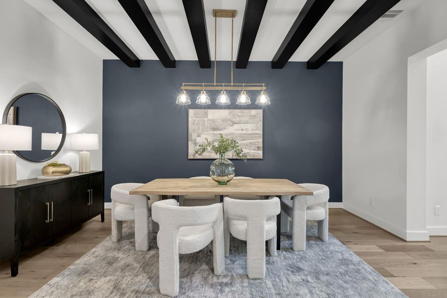 Formal dining room accented with dark blue walls and exposed ceiling beams. Formal dining room accented with dark blue walls and exposed ceiling beams.