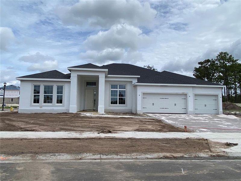 Front exterior of a new home in Hawk's Overlook, Oviedo, FL, highlighting curb appeal (Image 28). Front exterior of a new home in Hawk's Overlook, Oviedo, FL, highlighting curb appeal (Image 28).