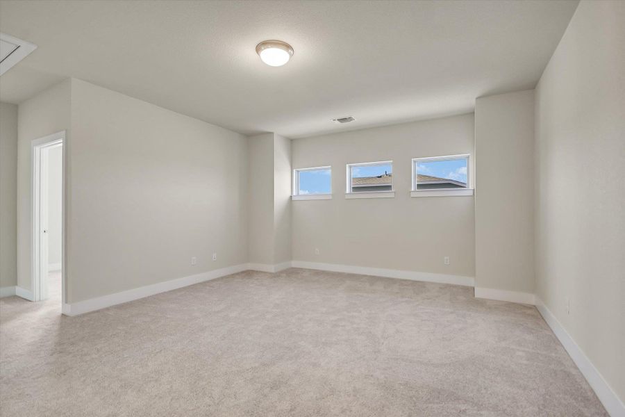 High windows invite natural light across the plush neutral carpeting of this versatile upper-level space. High windows invite natural light across the plush neutral carpeting of this versatile upper-level space.