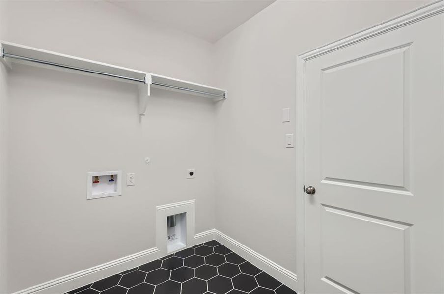 Washroom featuring gas dryer hookup, tile patterned floors, hookup for an electric dryer, and washer hookup