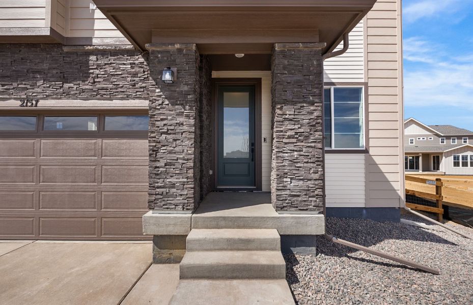 Exterior details and patio area of a home in Harvest Crossing, Aurora (Image 20).