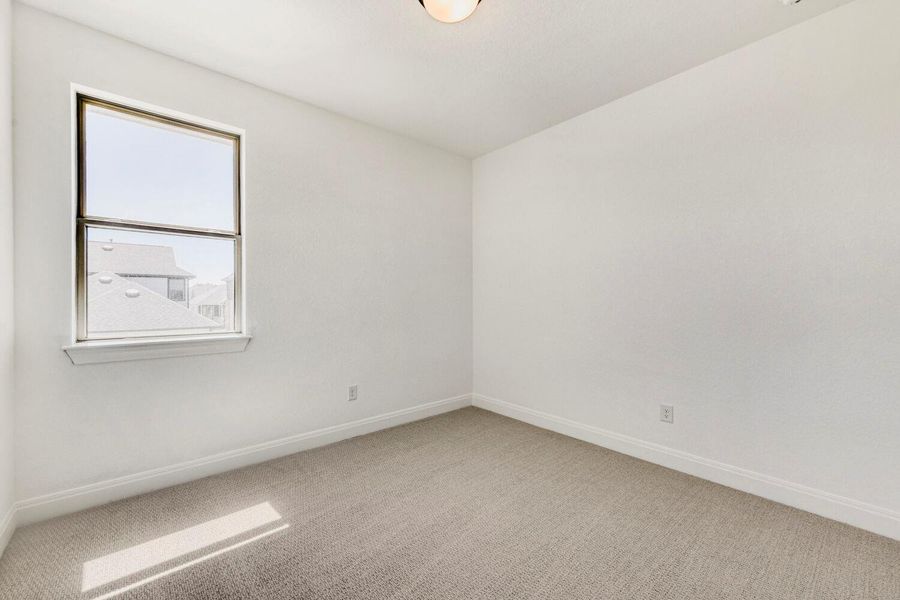 Spare room featuring light colored carpet and baseboards Spare room featuring light colored carpet and baseboards
