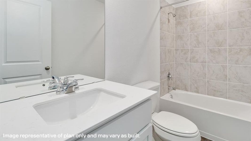 Bathroom with vanity, shower / tub combination, and a textured wall