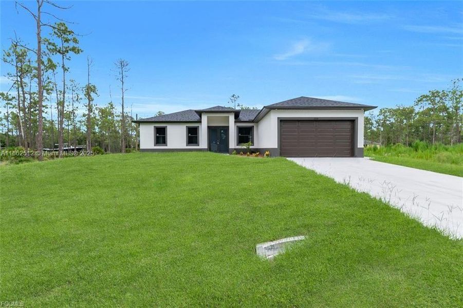 Front exterior of a new home in , Lehigh Acres, FL, highlighting curb appeal (Image 16).