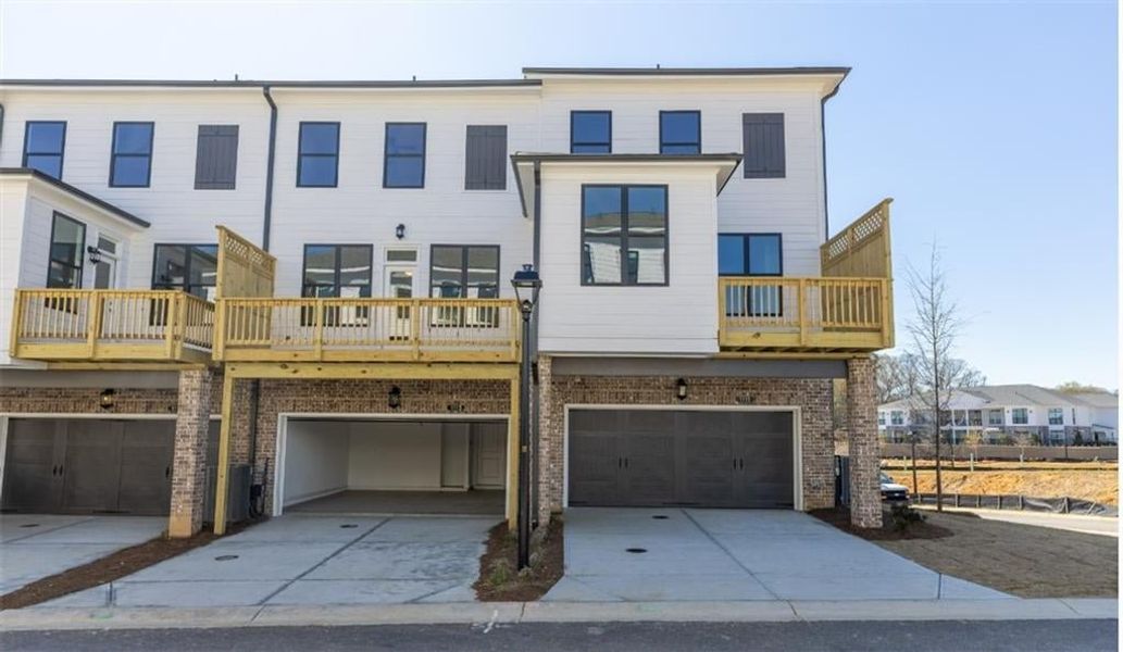 Driveways are in the back of the home.  Decks will face the woods for extra privacy. Picture not of actual home for representation purposes only.