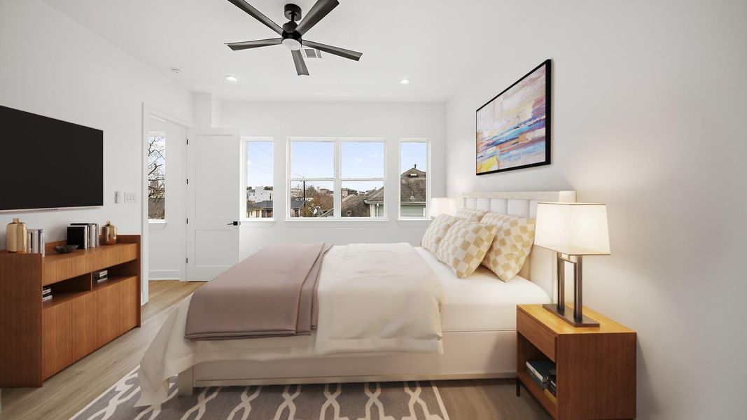 Virtually Staged: Spacious primary bedroom located on the third floor, featuring recessed lighting, a ceiling fan, and luxury vinyl plank floors.