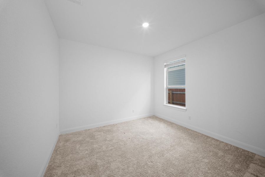 Carpeted spare room featuring baseboards and recessed lighting Carpeted spare room featuring baseboards and recessed lighting