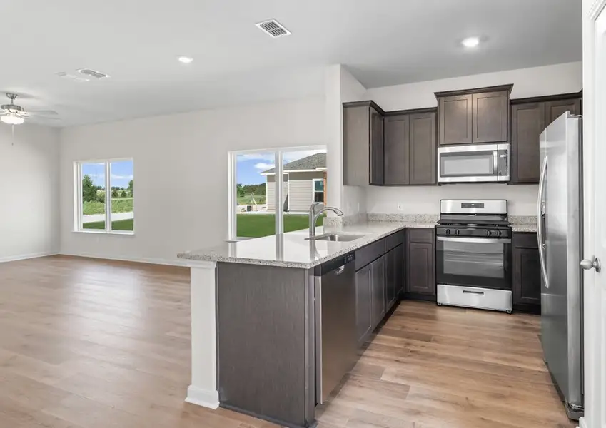The kitchen has stainless steel appliances.