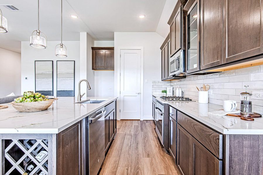 From this angle, the kitchen truly shines—stacked cabinetry, stainless steel appliances, and a timeless backsplash all working in perfect harmony. From this angle, the kitchen truly shines—stacked cabinetry, stainless steel appliances, and a timeless backsplash all working in perfect harmony.