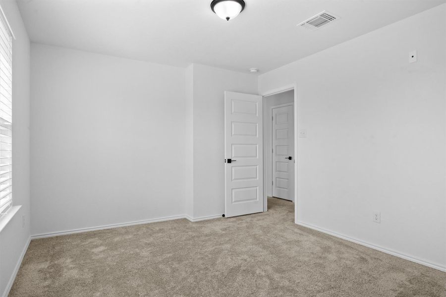 Empty room featuring carpet flooring and baseboards