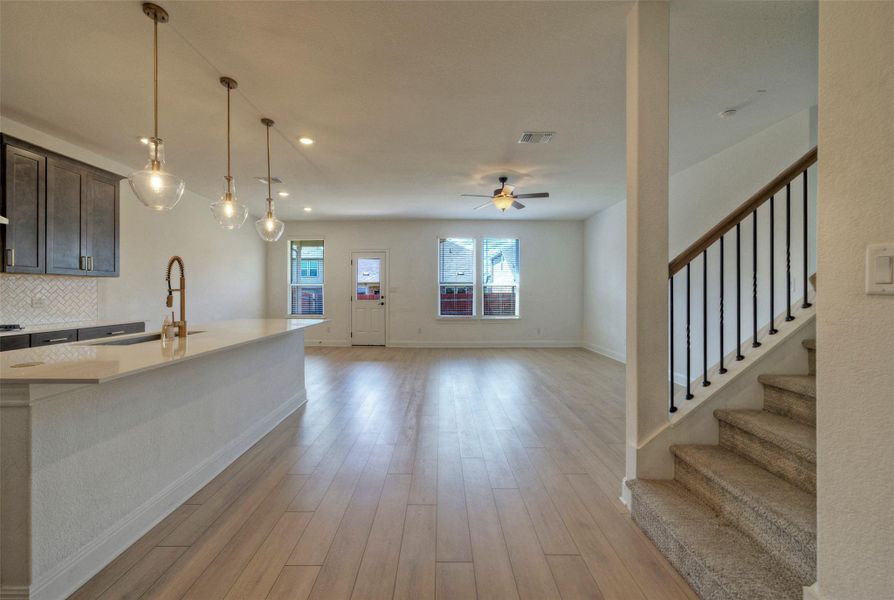Hardwood floors and an open concept layout connect the kitchen with the main living space. Hardwood floors and an open concept layout connect the kitchen with the main living space.
