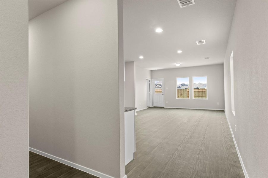 Hallway with recessed lighting and wood finished floors