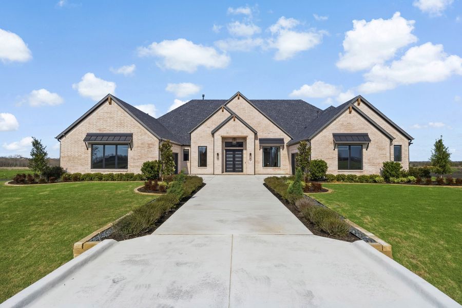 Front exterior of a new home in Ridge Pointe Estates, McLendon-Chisholm, TX, highlighting curb appeal (Image 2). Front exterior of a new home in Ridge Pointe Estates, McLendon-Chisholm, TX, highlighting curb appeal (Image 2).