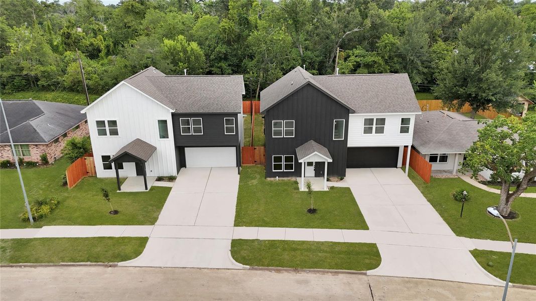 Large driveway leading to attached garage with modern exterior.