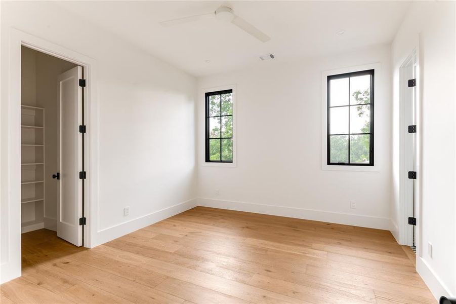 Spare room featuring light wood-type flooring and ceiling fan